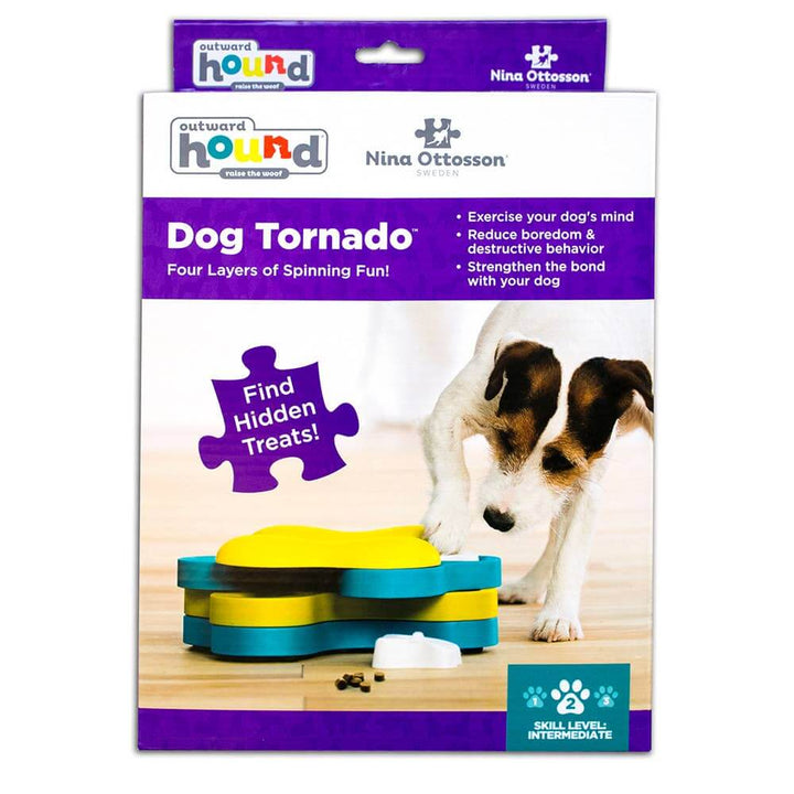 Outward Hound Dog Tornado puzzle toy in retail packaging with a dog sniffing the toy on wood floor.