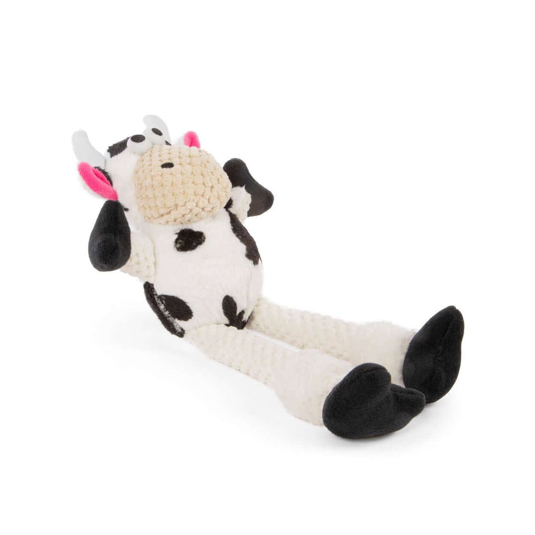 Black and white plush cow dog toy with floppy legs and pink ears, soft squeaky toy for interactive play