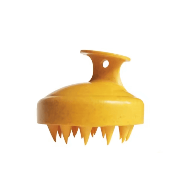 Close-up of Monty's ergonomic dog shampoo brush in bright yellow with soft, flexible bristles for grooming and massaging pets.