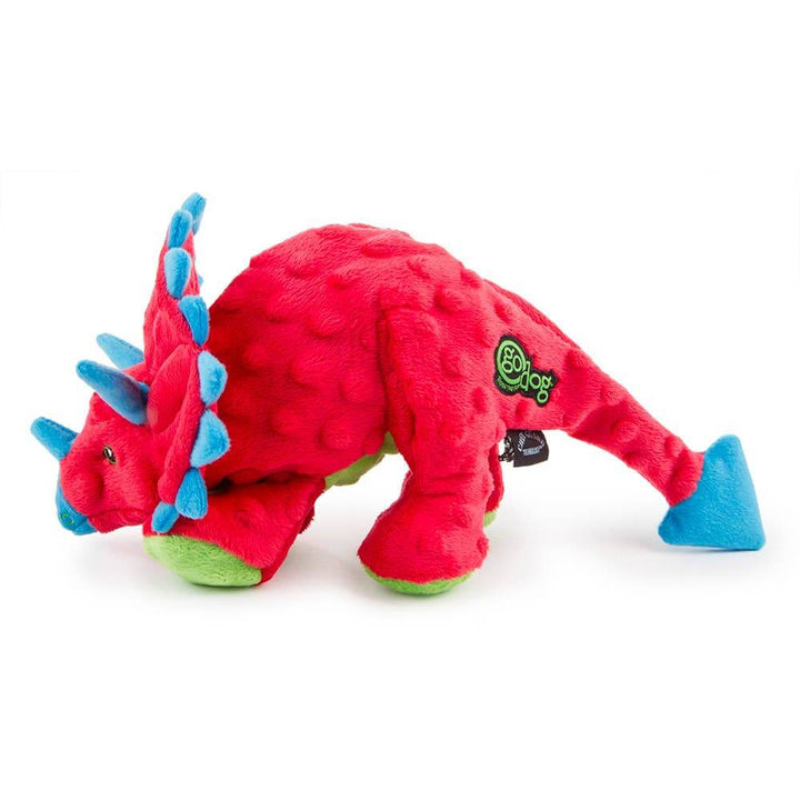Red dinosaur toy with blue spikes on a white background