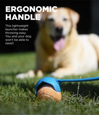 Close-up of a ball inside the Outward Hound launcher, with a dog in the background, highlighting the ergonomic handle for easy use.