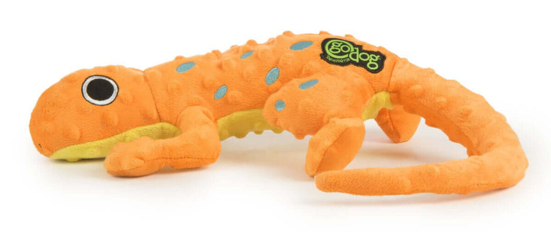 Orange plush lizard-shaped dog toy with black and white eyes, blue spots, yellow underside, and a "goDog" logo, ideal for interactive play.