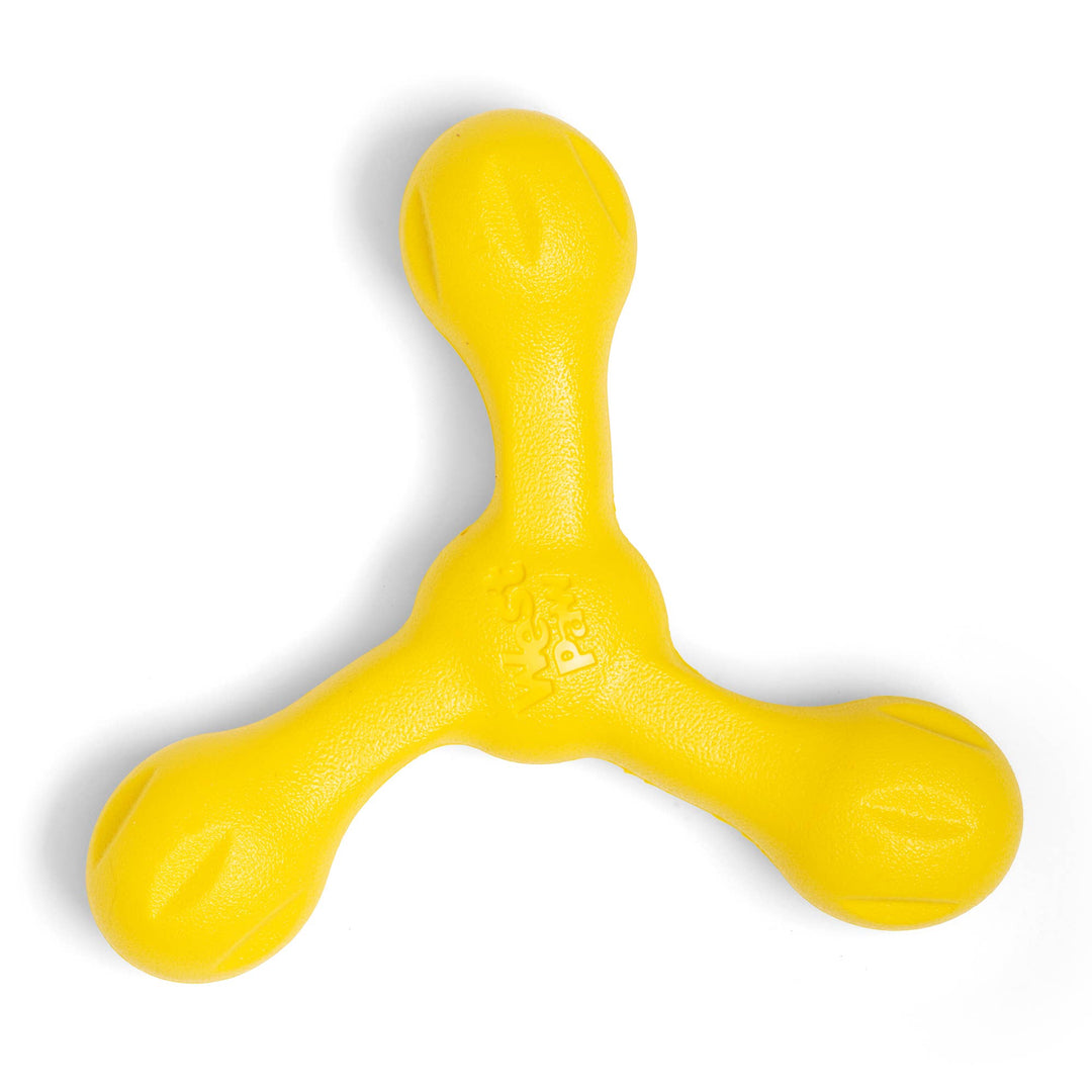 Yellow rubber dog toy on a white background