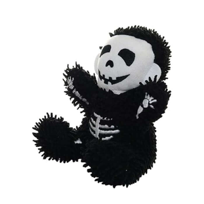 Black and white skeleton plush dog toy on a white background
