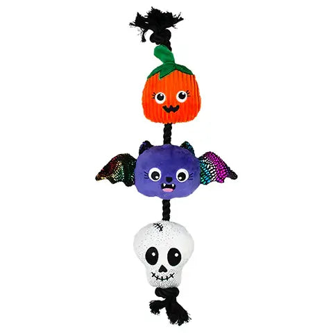 Stack of Halloween-themed plush toys including a bat, pumpkin, and skull on a white background