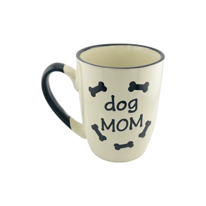 A ceramic mug with a white base and black handle, featuring the text 'dog DAD' in the center surrounded by small black bone shapes. The mug has a simple and clean design, suitable for dog lovers, especially those who consider themselves dog dads.