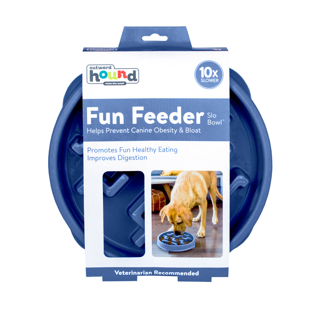 Product image of a blue 'Fun Feeder Slo Bowl' by Outward Hound. The packaging highlights its benefits, stating that it helps prevent canine obesity and bloat, promotes fun and healthy eating, and improves digestion. The packaging features a photo of a yellow Labrador Retriever eating from the bowl, with text indicating the product is veterinarian recommended.