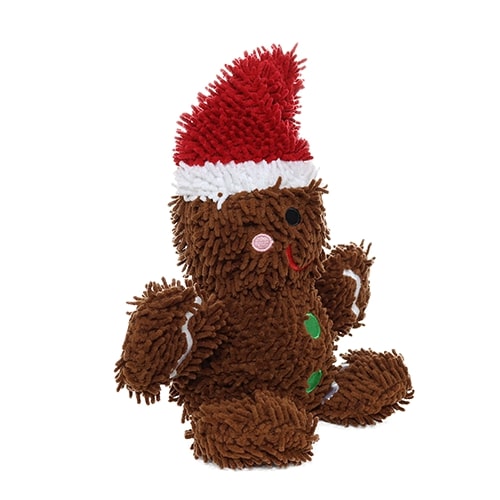 Side view of a gingerbread man plush dog toy, featuring a Santa hat, green buttons, and white accents on the arms, with a soft microfiber texture.