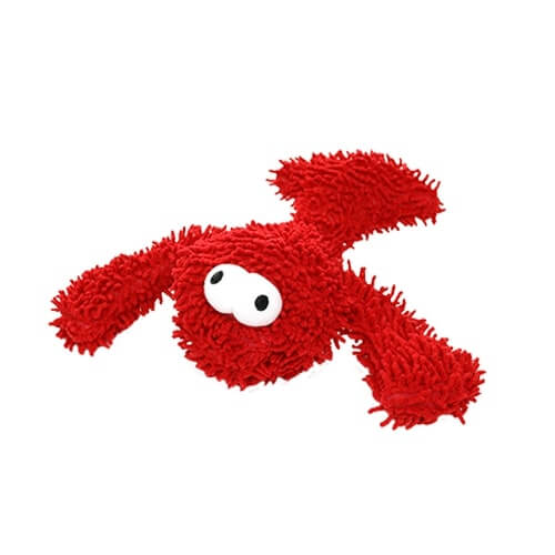 A red plush dog toy with large white and black eyes, featuring a textured, shaggy surface, designed for interactive play.