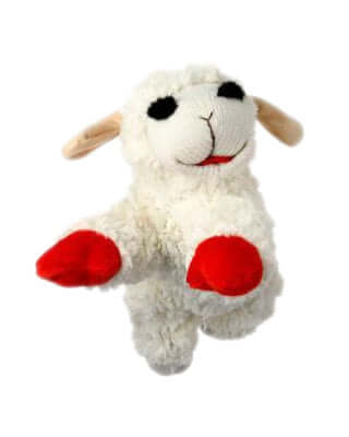 A plush dog toy fashioned after the character Lamb Chop, with a fluffy white body and striking red accents on its feet and ears. The toy has a sweet, smiling expression with black stitched eyes and a simple line for a mouth, making it resemble the classic puppet. Its soft texture and playful design make it a comforting and fun toy for pets. The background is not visible, focusing all attention on the toy itself.