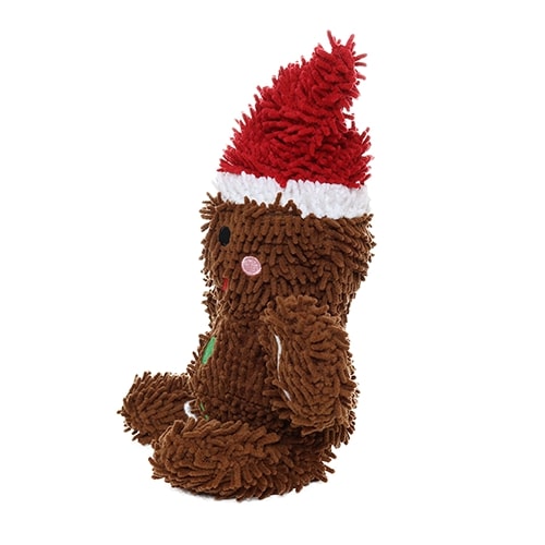 Another side view of the gingerbread man plush dog toy, wearing a Santa hat, with a soft microfiber texture and holiday-themed design.