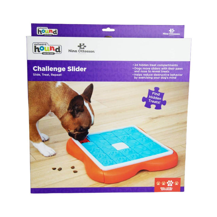 French Bulldog interacting with Outward Hound Nina Ottosson Challenge Slider dog puzzle on wood floor—perfect for mental stimulation and treat discovery.