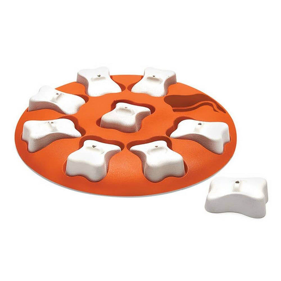 Outward Hound Dog Smart Puzzle in orange with white bone-shaped covers—entry-level treat-dispensing game for dogs learning puzzle toys.