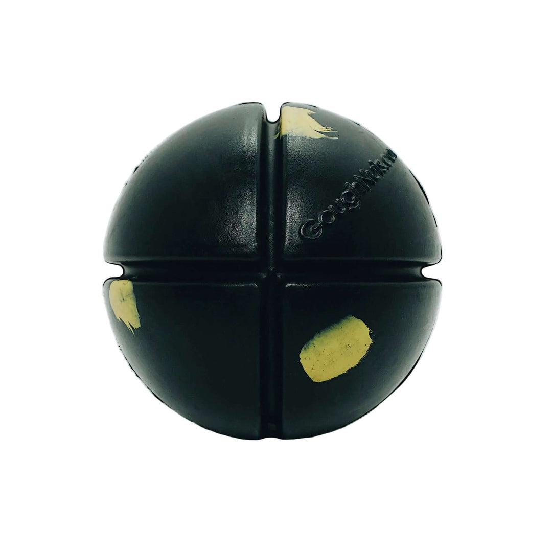 A black rubber dog toy shaped like a four-quadrant sphere, with yellow painted patches and the brand name 'Coogdog' embossed on one section, set against a plain white background.