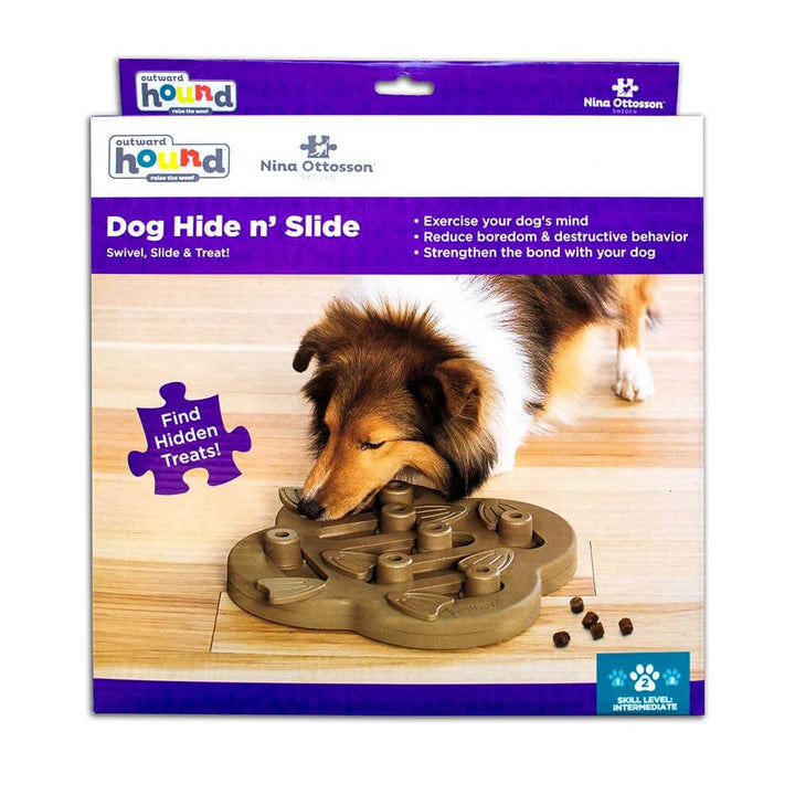 Sheltie using the Nina Ottosson Dog Hide N’ Slide puzzle by Outward Hound—interactive treat-hiding toy for mental enrichment and boredom relief.