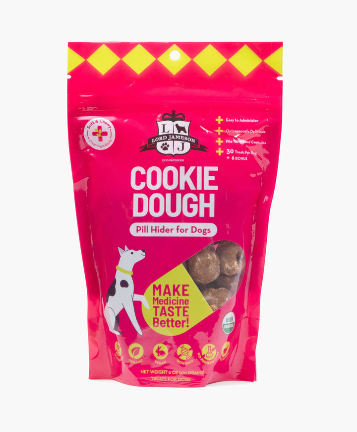 Pink package of 'Cookie Dough' pill hider for dogs with a cartoon dog on a white background