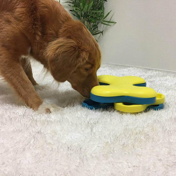 Golden retriever engaging with the Dog Tornado puzzle toy to find hidden treats.
