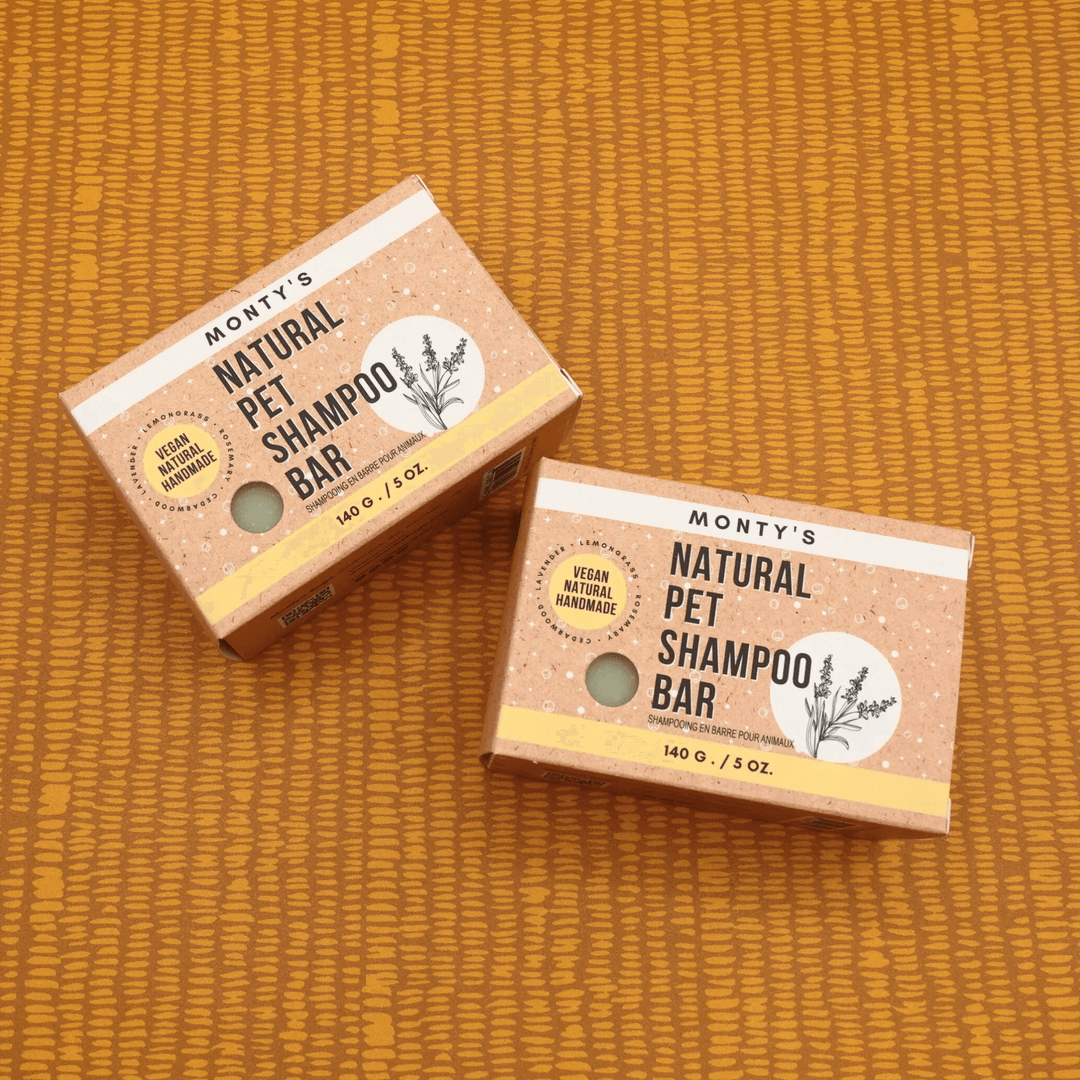 Two Monty's Natural Pet Shampoo Bars, 140g each, vegan, handmade, natural grooming soap for pets, displayed on orange fabric.