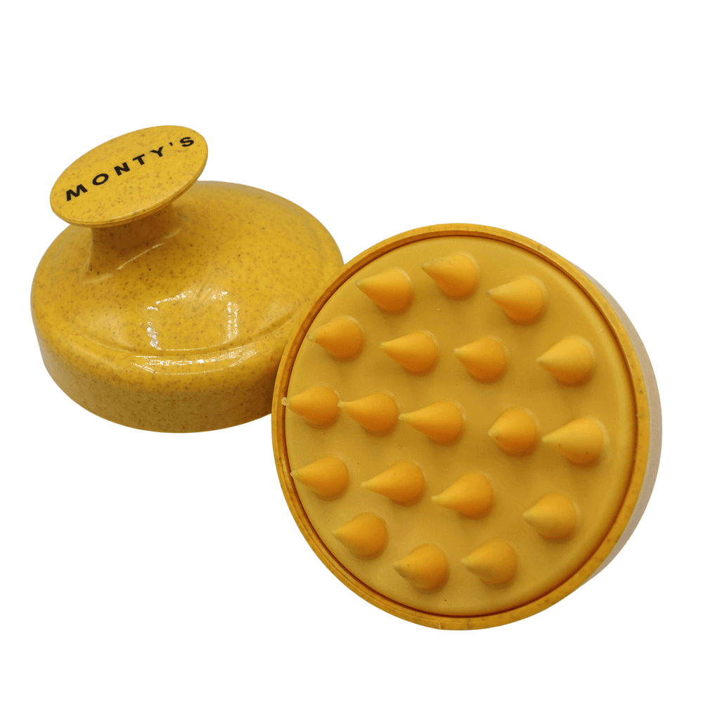 Monty's yellow dog shampoo brush with ergonomic handle and soft bristles, ideal for pet grooming, massaging, and scrubbing fur.
