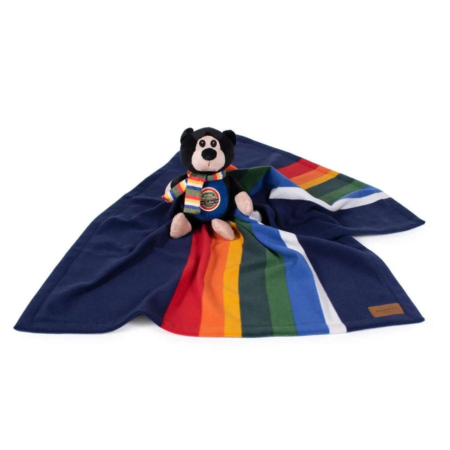 Soft fleece dog blanket with multicolor stripes and plush Pendleton bear toy from National Park Collection – cozy dog gift set on white background.