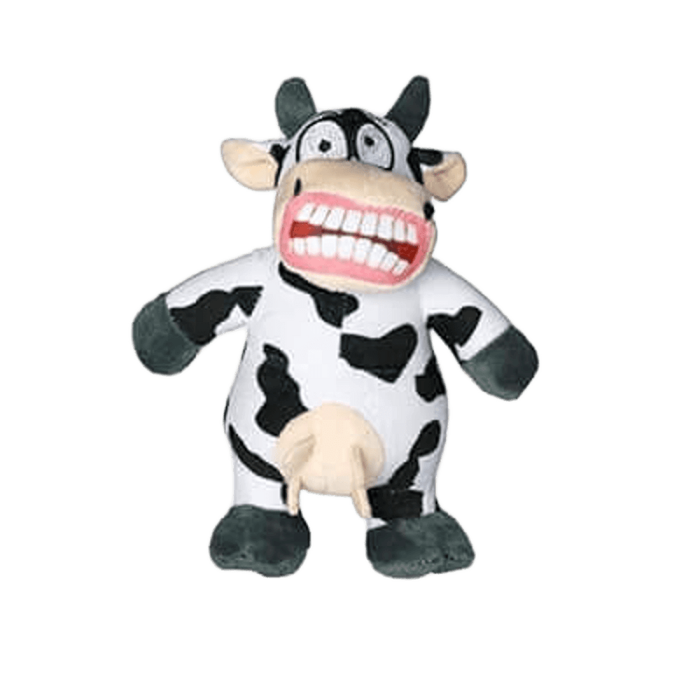 Cow-shaped dog toy with black and white plush body, wide eyes, a large grinning mouth with big teeth, and udder detail. Designed for fun interactive play.