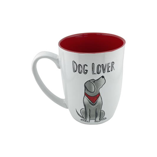 A charming white ceramic mug with a red interior, featuring an illustration of a sitting dog wearing a red bandana. The text "Dog Lover" is displayed above the dog graphic. This 24 oz mug is perfect for dog enthusiasts, adding a fun pop of color to your morning routine. Dishwasher and microwave safe.