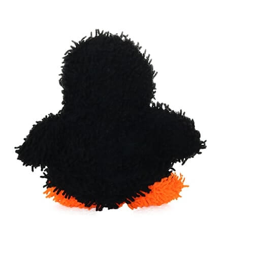 A rear view of a black plush penguin-shaped dog toy with shaggy microfiber material and orange feet.