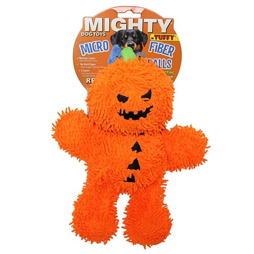 The image depicts a MIGHTY® Dog Toy called "Microfiber Ball Pumpkin Man." The toy is bright orange and shaped like a pumpkin with a jack-o'-lantern face. It is soft and fuzzy, designed for interactive play with dogs. The packaging indicates that the toy is durable, has minimal stuffing, and is suitable for machine washing.