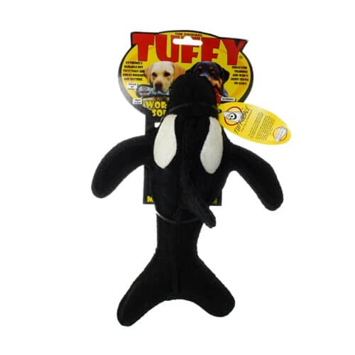 Black and white Tuffy killer whale-shaped dog toy, packaged for sale, with a durable soft design and yellow background.