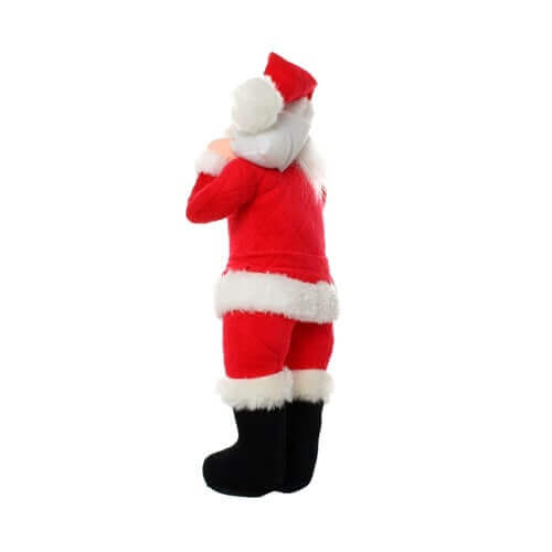 The image shows the back view of the same plush toy Santa Claus. The toy is dressed in a red suit with white trim, black boots, and a red hat with a white pom-pom. Santa is depicted holding a white sack over his shoulder, and you can see the details of the back of his suit and boots. The toy appears to be made of soft, plush material, with the white trim being fluffy and the red suit having a quilted pattern.