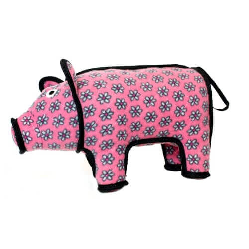 Side view of the plush pig dog toy, showing its pink floral pattern and soft plush body.