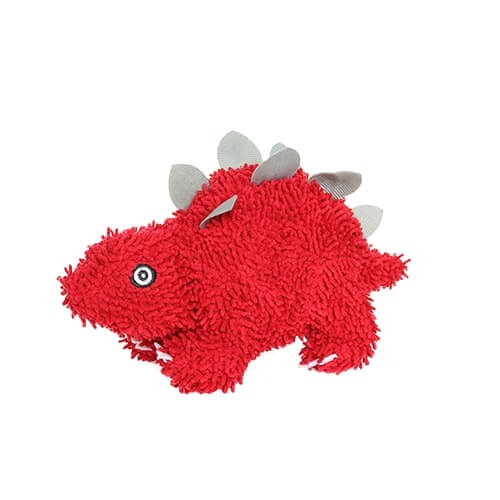 A side view of the red dinosaur plush toy, highlighting its shaggy texture and grey plates along its back.