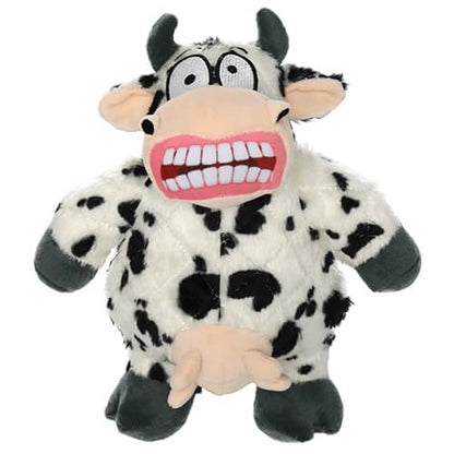 Plush cow-shaped dog toy with black spots, a wide grin showing large teeth, and udders, featuring a comical and exaggerated expression