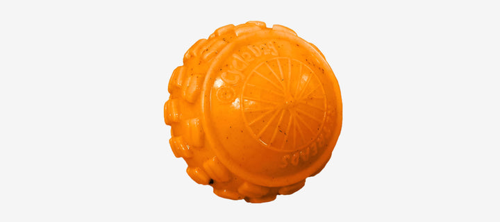 Orange rubber dog toys designed with a bumpy texture, in blue, green, and orange colors.
